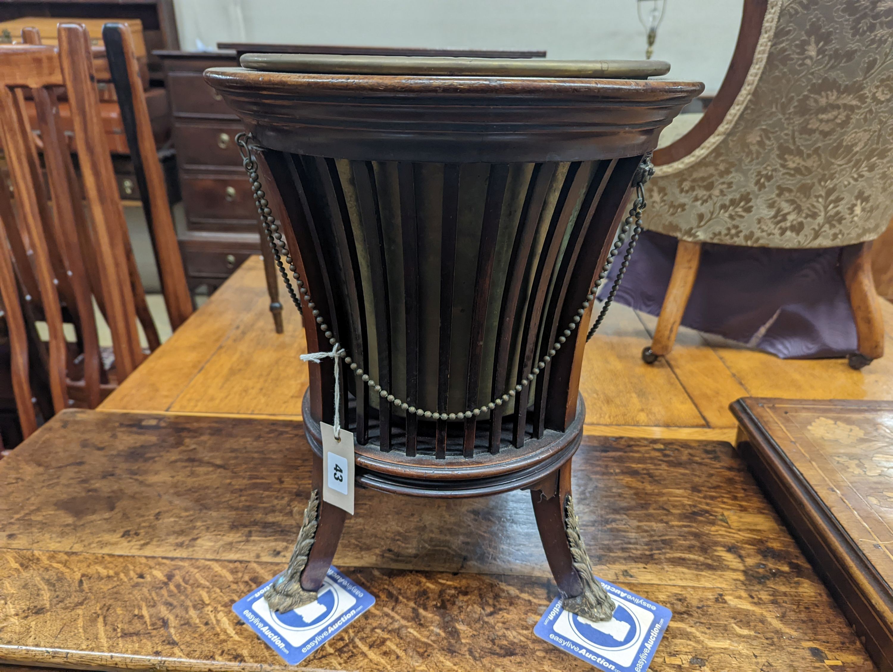 An Edwardian brass mounted mahogany jardiniere with brass liner, diameter 35cm, height 46cm